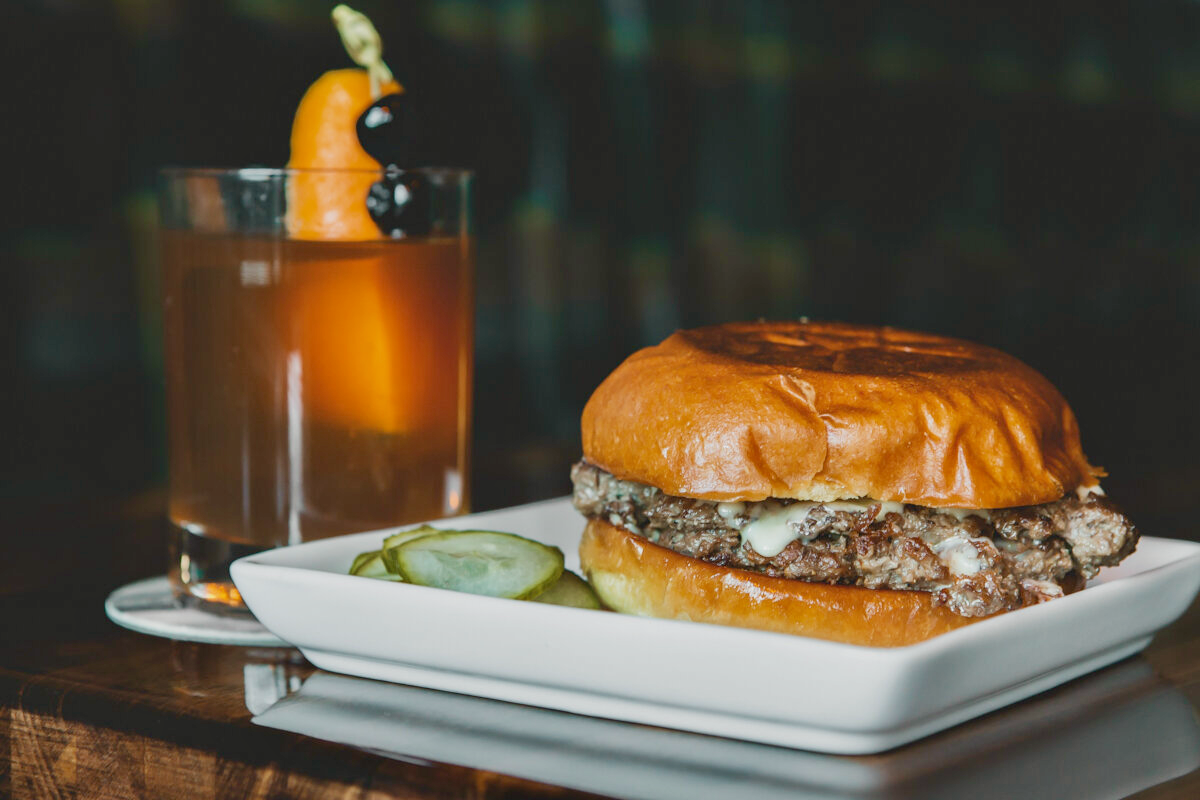 Dive into the world of craft cocktails and delicious smash burgers.