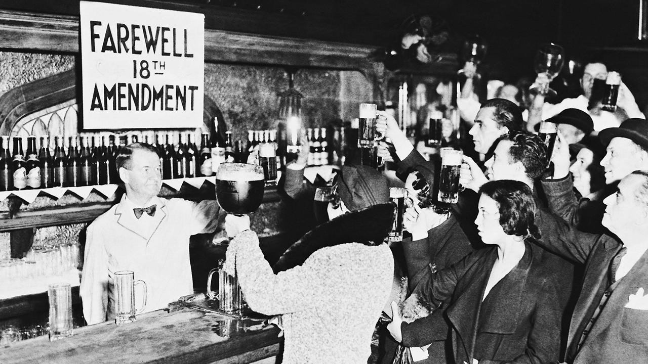 people at a bar raising a toast to the end of the prohibition