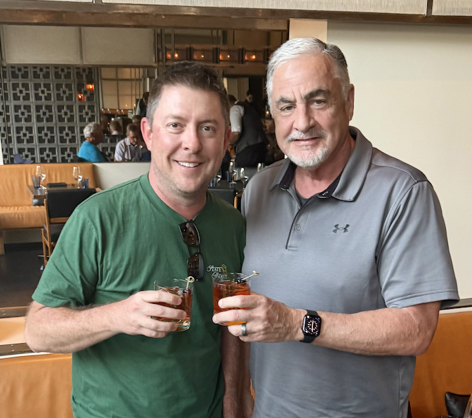 Chuck Swaney is enjoying an Old Fashioned with Audacy Country’s KMLE Program Director Drew Bland