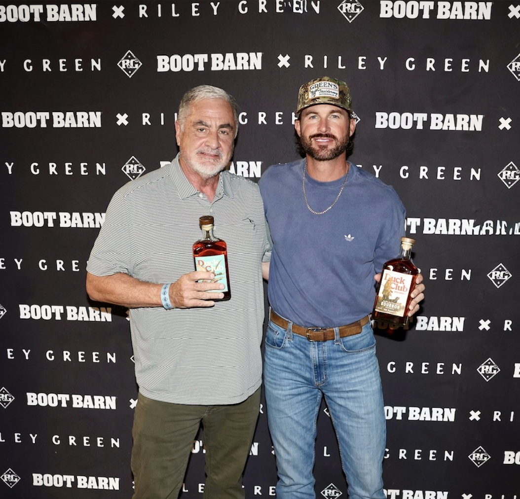 Chuck Swaney and Riley Green holding bottles of Duck Club Bourbon